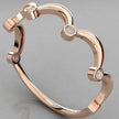 A perspective angled view of the Cloudia 14k rose gold wavy ring with six bezel-set diamonds.