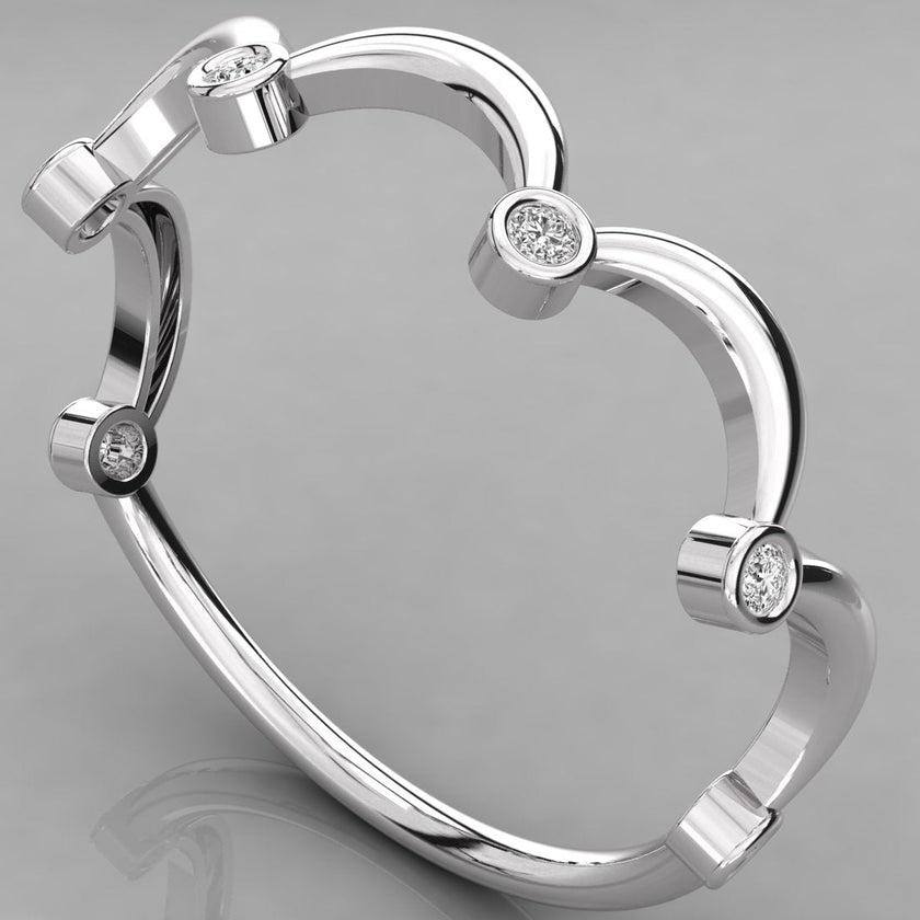 Three-quarter perspective of the Cloudia white gold ring, highlighting the sculptural wave design and bezel settings.