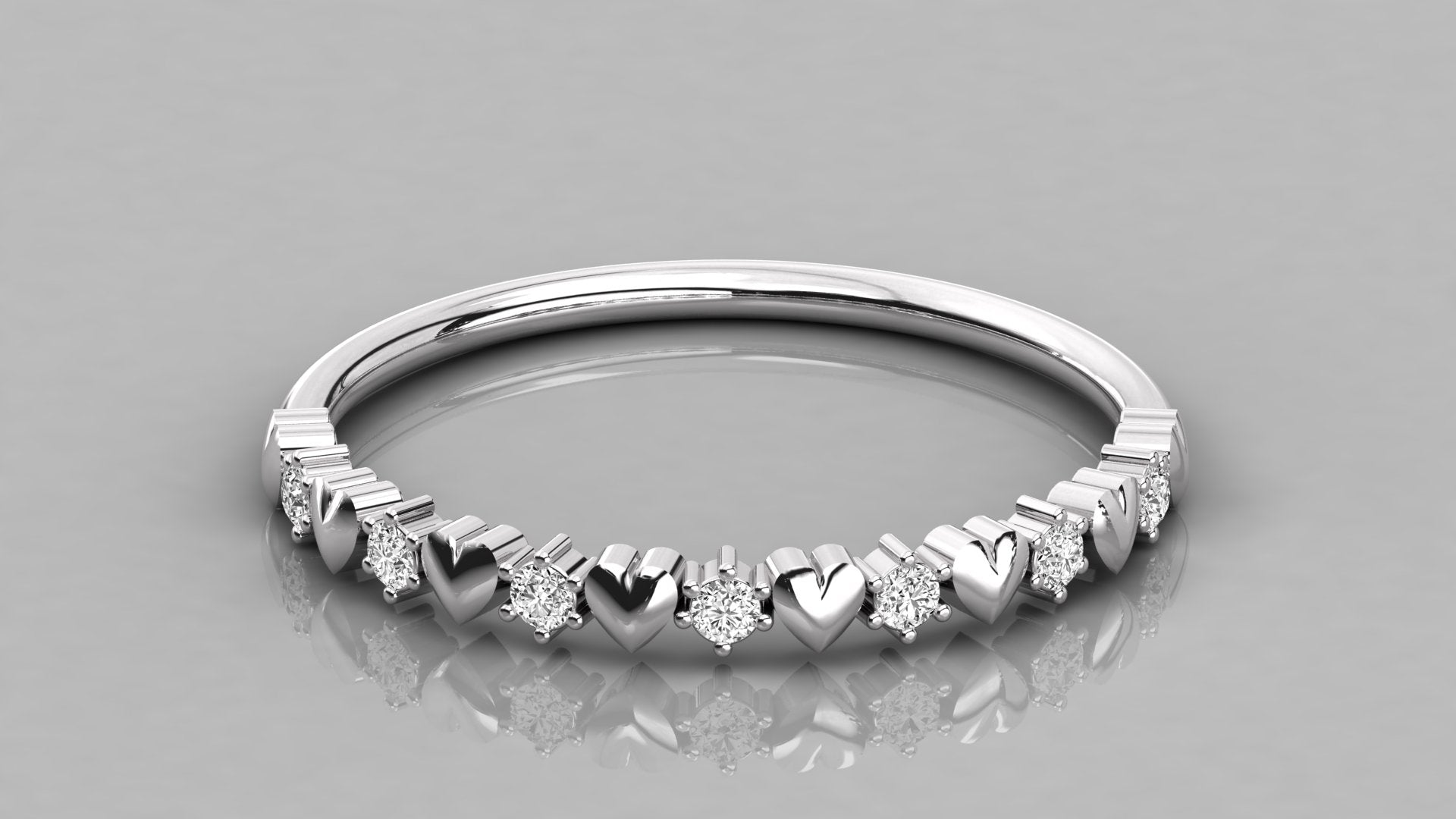 Professional low-angle shot of the Juliette 585 white gold heart-shaped eternity band set with ethical lab-created diamonds.