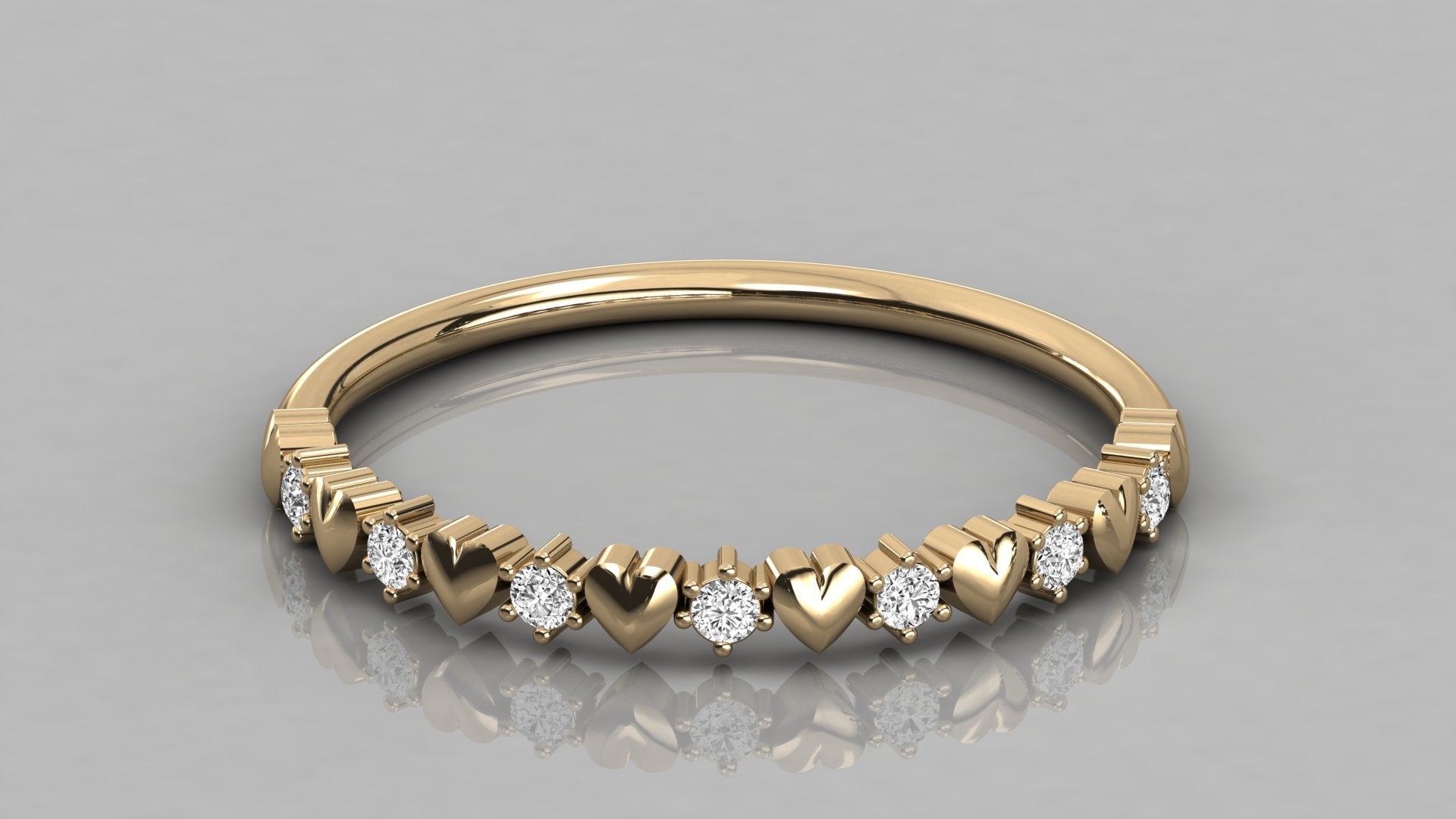 Detailed perspective low-angle view of the Juliette yellow gold heart ring, showcasing the high-polish finish and sparkling lab diamonds.