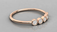 Side perspective of the Luna rose gold 585 minimalist band lying down, showcasing five ethical lab-created diamonds.