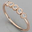 Perspective angled view of the Luna 14k rose gold stackable ring featuring five 2.0mm lab-grown diamonds in a minimalist bezel setting.