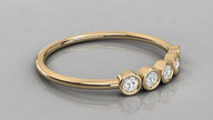 Horizontal lying view of the Luna yellow gold 585 stackable ring, highlighting the high-polish gold finish and stones.