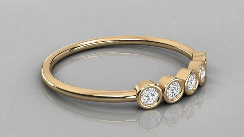 Horizontal lying view of the Luna yellow gold 585 stackable ring, highlighting the high-polish gold finish and stones.