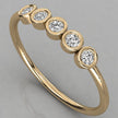 Perspective shot of the Luna 14k yellow gold minimalist ring with 5 sparkling 2.0mm diamonds in an eternity-style setting.