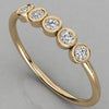 Perspective shot of the Luna 14k yellow gold minimalist ring with 5 sparkling 2.0mm diamonds in an eternity-style setting.