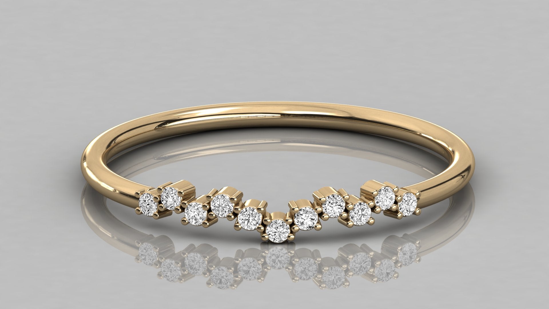 Close-up front view of the Lyra yellow gold stackable ring, highlighting the elegant V-shape and diamond setting.
