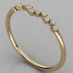 An angled perspective shot of the Lyra 14k yellow gold wishbone ring featuring a radiant row of lab-grown diamonds.