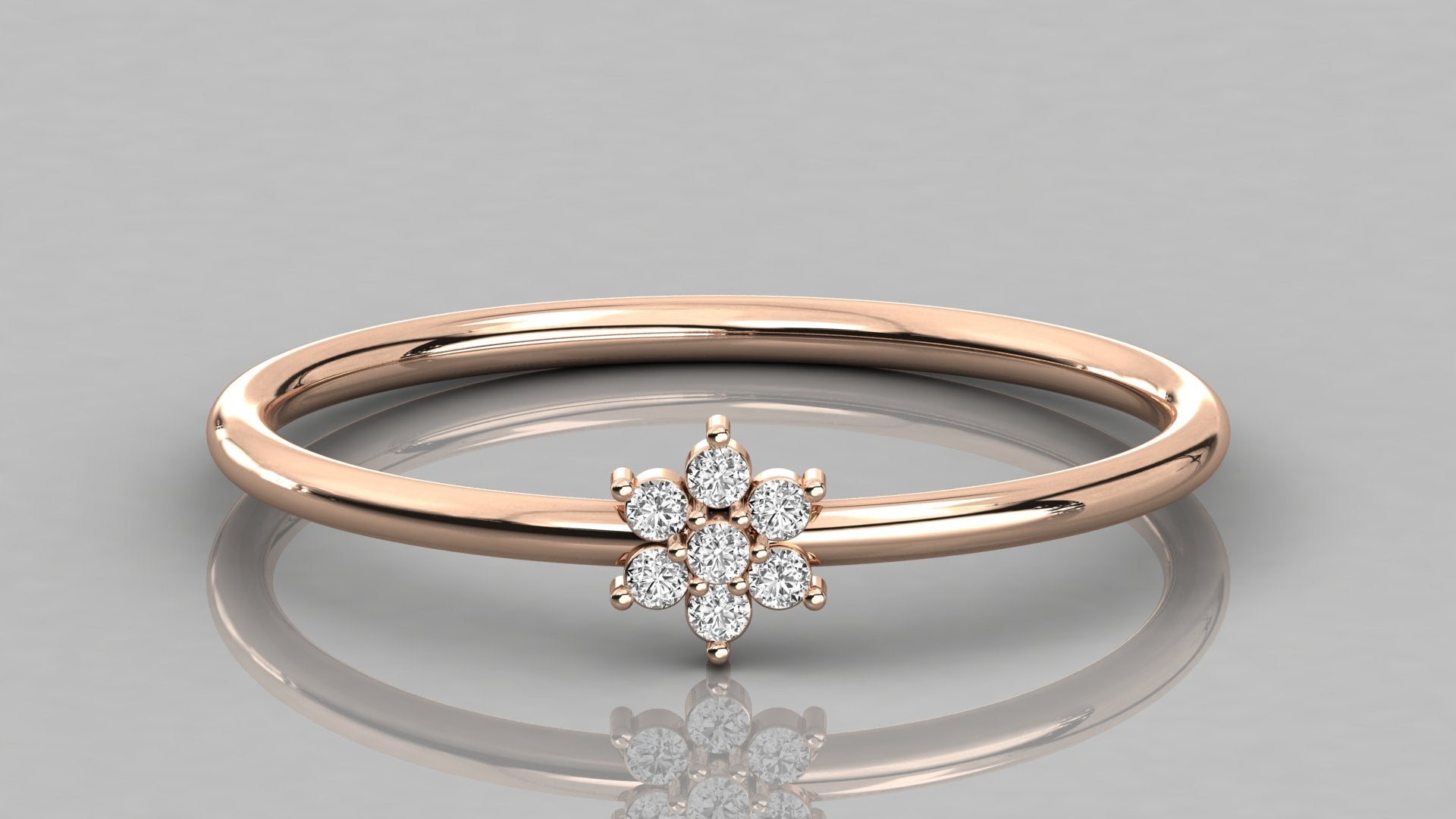 Direct frontal shot of the Mira 14k rose gold ring focusing on the seven lab diamonds in a botanical flower setting.
