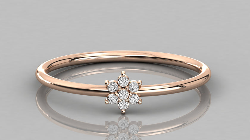 Direct frontal shot of the Mira 14k rose gold ring focusing on the seven lab diamonds in a botanical flower setting.