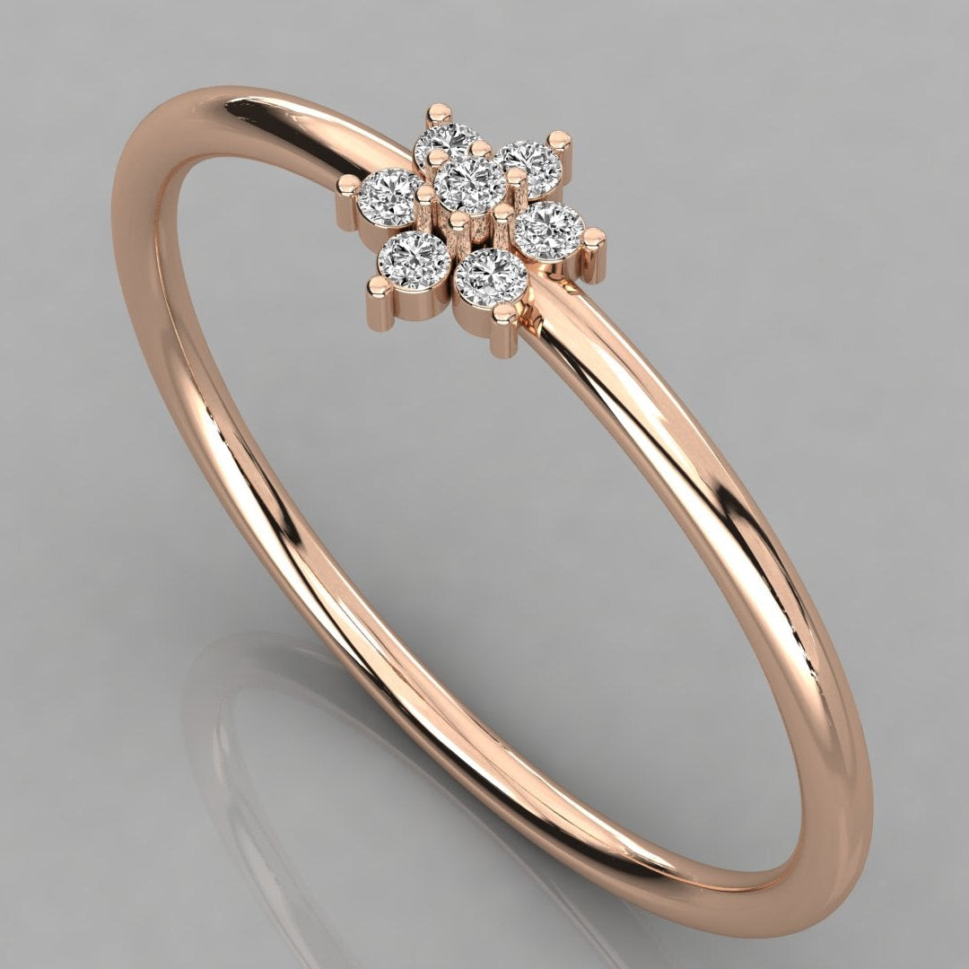 Perspective angled view of the Mira 14k rose gold ring with a sparkling seven-diamond flower design.