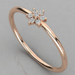 Perspective angled view of the Mira 14k rose gold ring with a sparkling seven-diamond flower design.