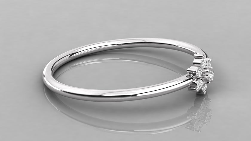 Horizontal lying shot of the Mira white gold ring emphasizing the cool metal and sparkling diamond blossom.