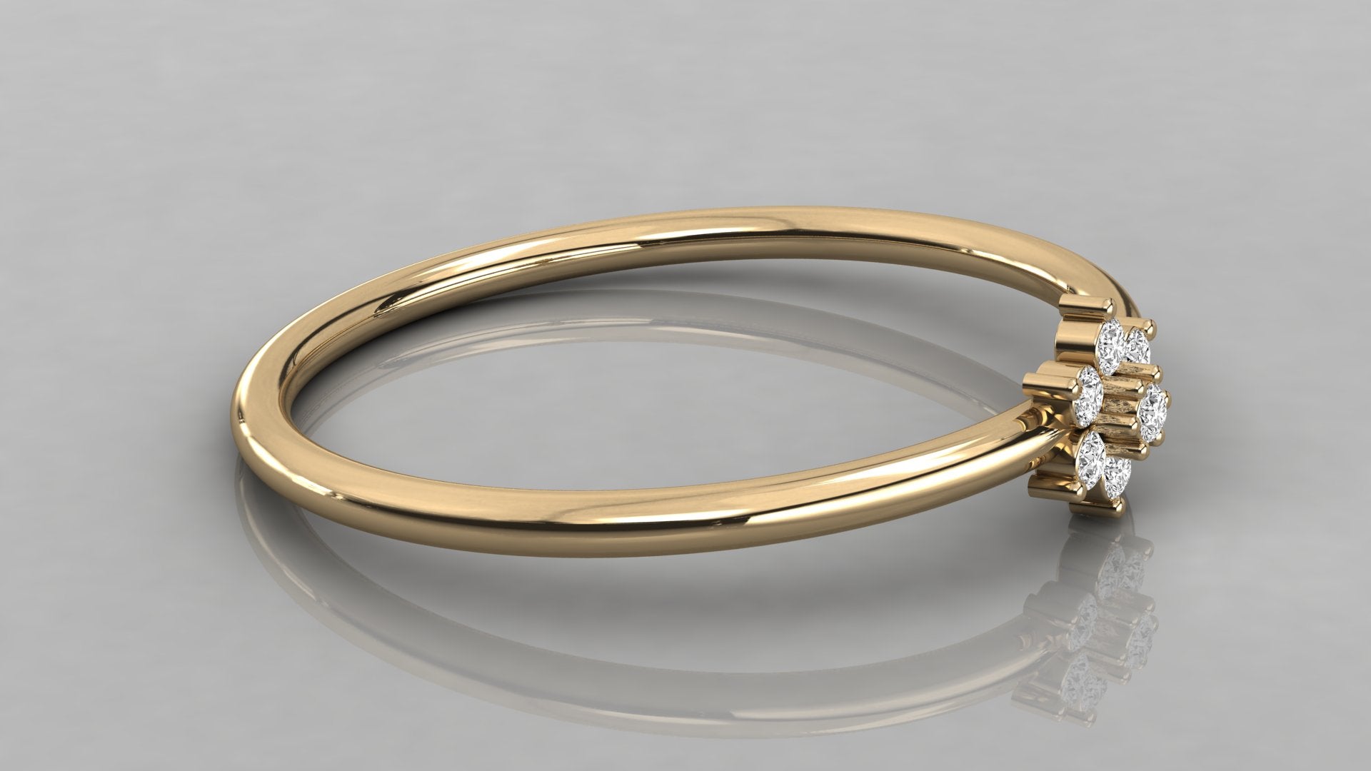 Low-angle lying view of the Mira yellow gold ring highlighting the high-polish finish and petal-like stones.