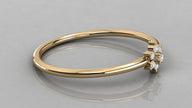 Low-angle lying view of the Mira yellow gold ring highlighting the high-polish finish and petal-like stones.