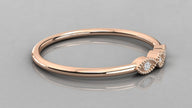 Side perspective of the Selene rose gold vintage band lying on a surface, highlighting the intricate milgrain texture.