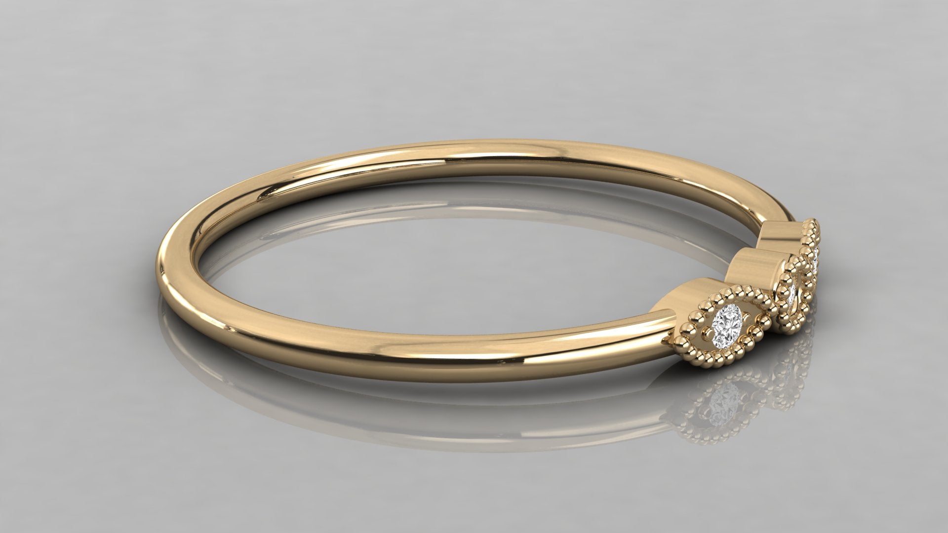 Side perspective of the Selene yellow gold trilogy ring lying down, showcasing the rich gold glow and sustainable diamonds.