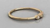 Side perspective of the Selene yellow gold trilogy ring lying down, showcasing the rich gold glow and sustainable diamonds.