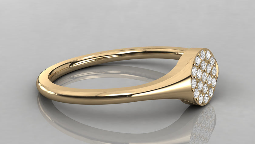Horizontal view of the Stella yellow gold signet ring lying down, showcasing the rich gold glow and low-profile diamond setting.